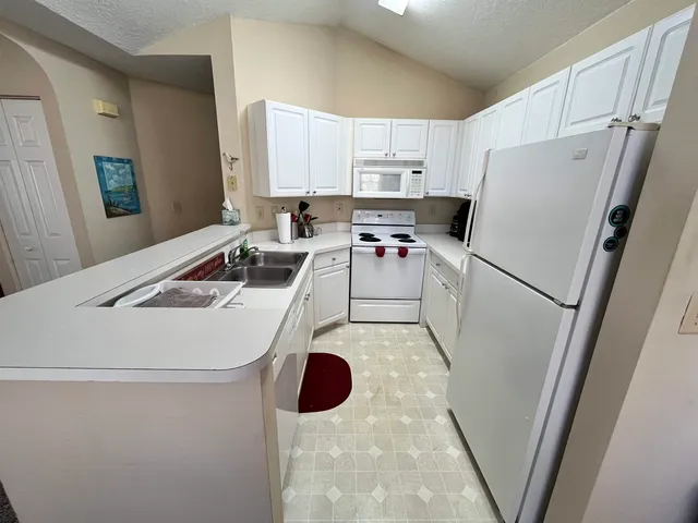 a kitchen with a stove a sink and a refrigerator