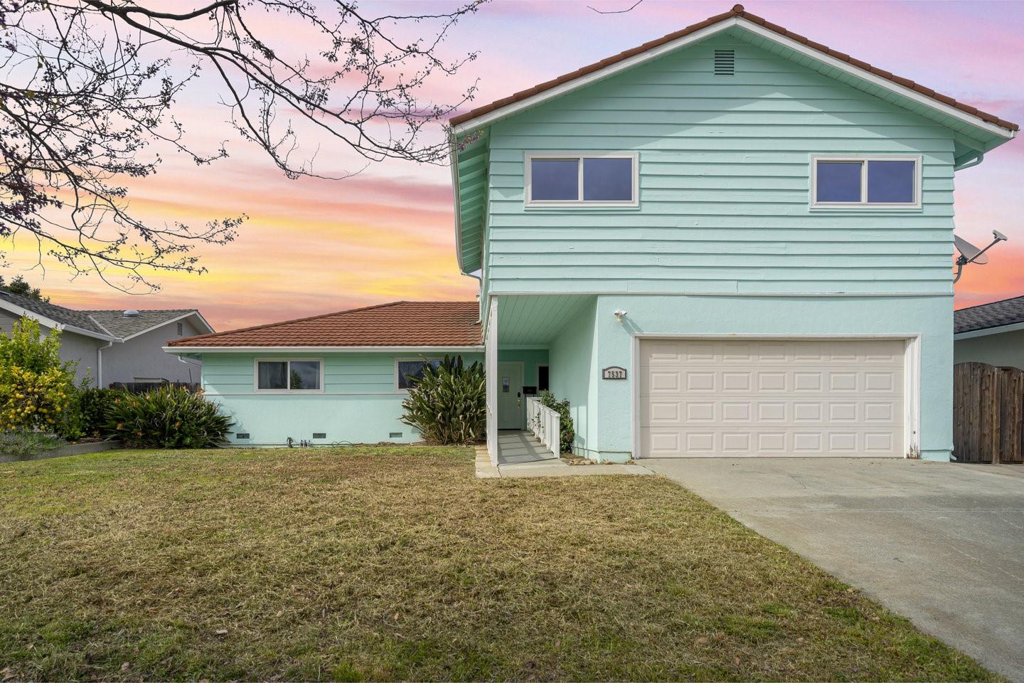a front view of a house with a garden