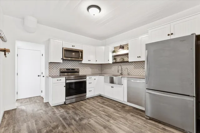 a kitchen with a refrigerator stove and microwave