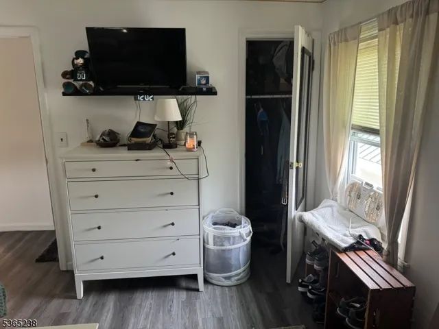 a room with a chair and a flat screen tv