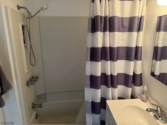 a bathroom with a bathtub and shower