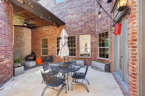 a view of an outdoor sitting area with brick walls