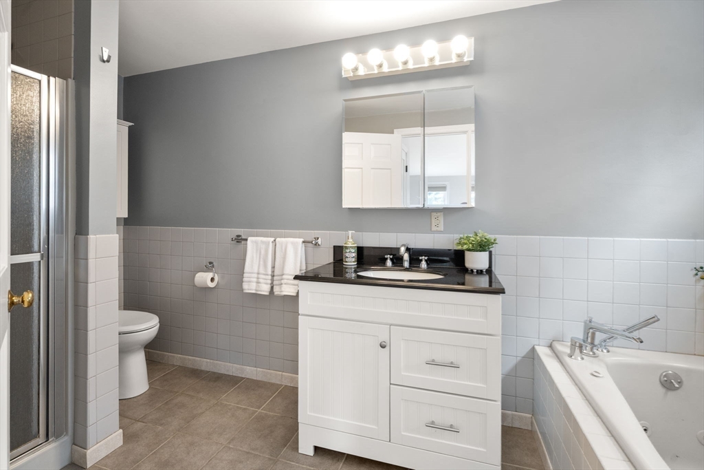 10 Wright Road Sudbury, MA 01776 - Photo 12 of 27 a bathroom with a sink a toilet and mirror