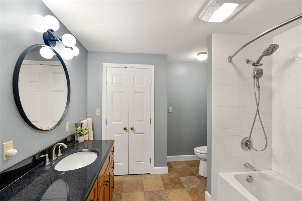 10 Wright Road Sudbury, MA 01776 - Photo 15 of 27 a bathroom with a granite countertop sink toilet and a mirror
