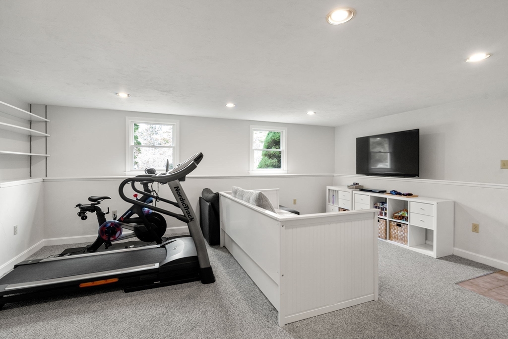 10 Wright Road Sudbury, MA 01776 - Photo 18 of 27 a living room with furniture and a flat screen tv
