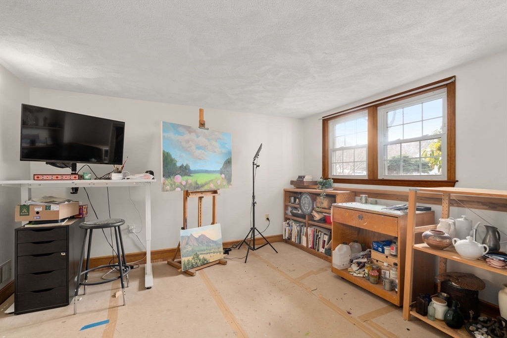 10 Wright Road Sudbury, MA 01776 - Photo 20 of 27 a bedroom with furniture and a flat screen tv