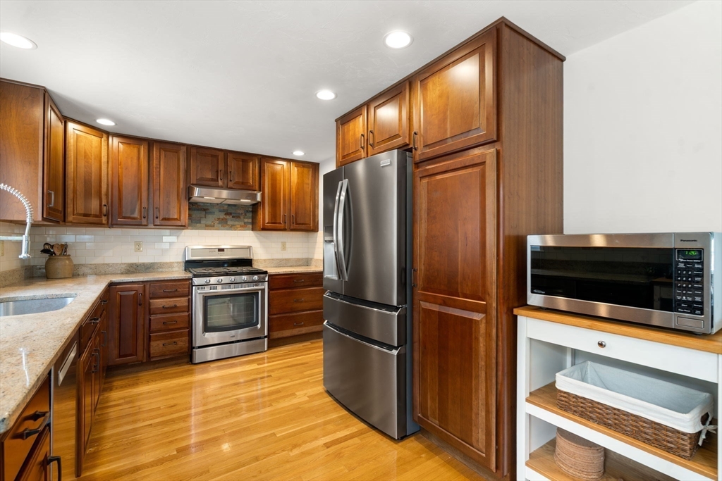 10 Wright Road Sudbury, MA 01776 - Photo 6 of 27 a kitchen with granite countertop a refrigerator stove and microwave
