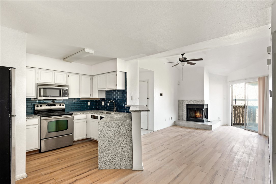 a kitchen with stainless steel appliances a stove top oven and sink