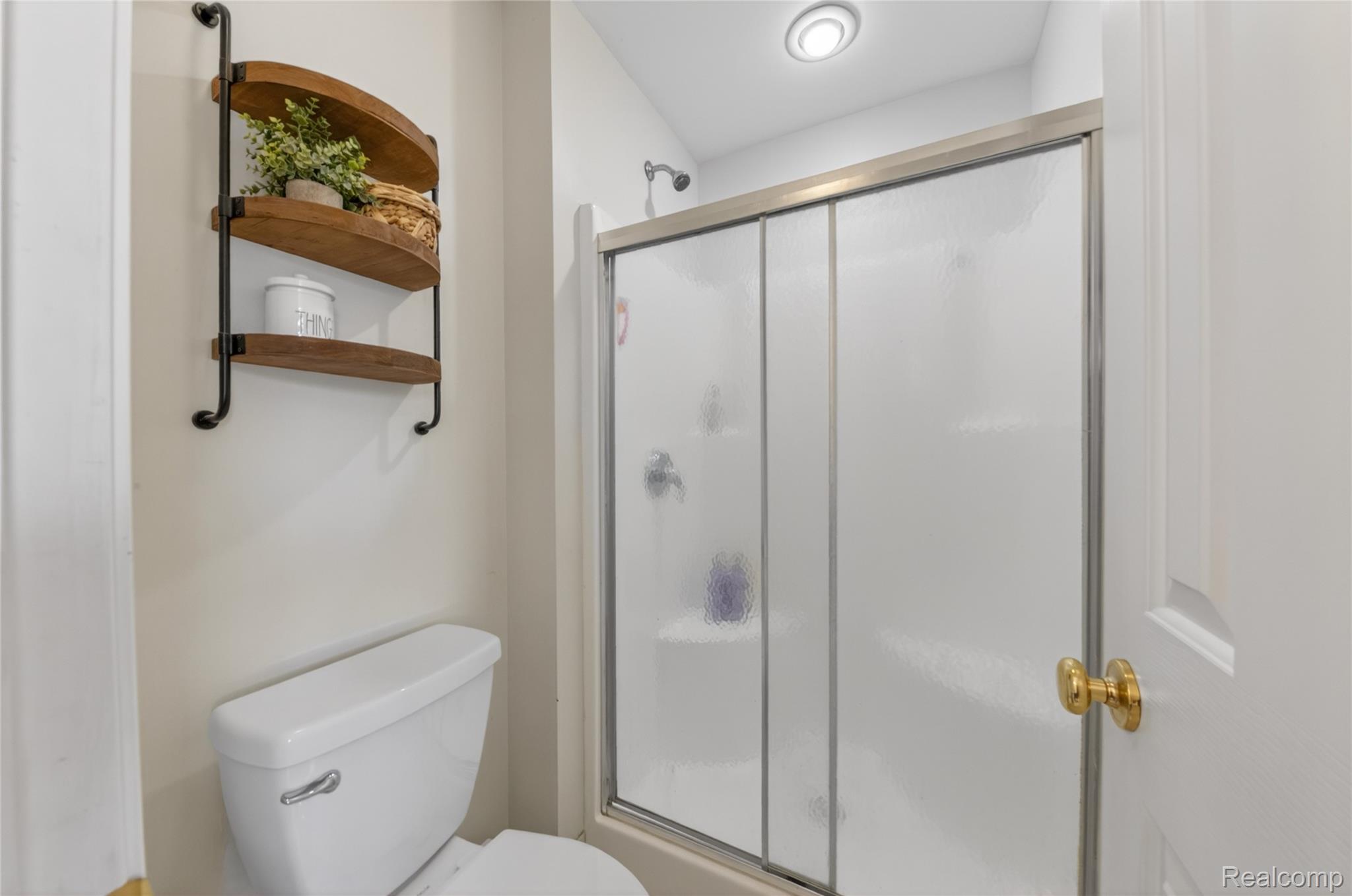 9191 Judd Road Fowlerville, MI 48836 - Photo 34 of 74 Shower with frosted glass enclosure and silver-tone framing