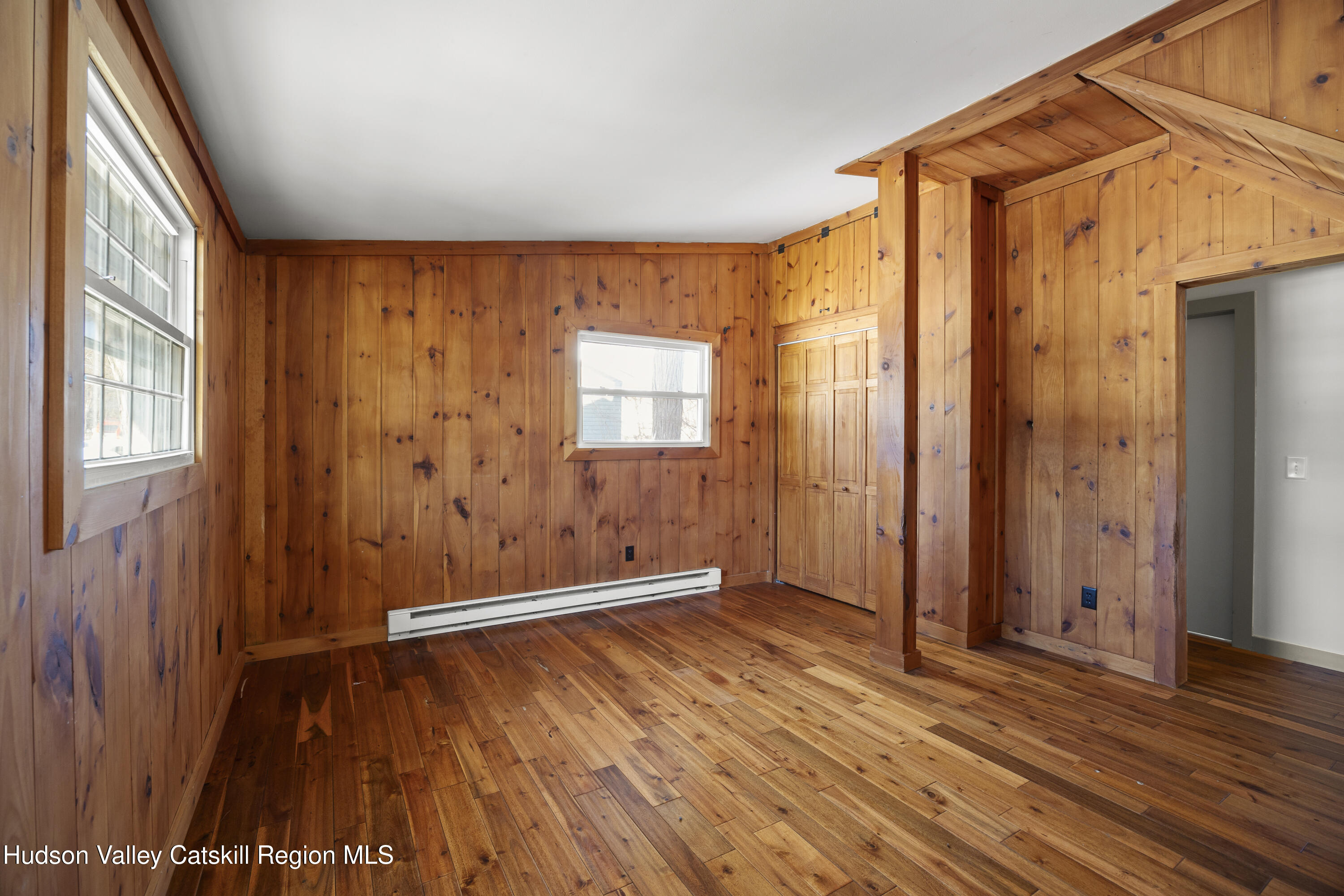 116 Lincoln Road Copake, NY 12516 - Photo 5 of 20 an empty room with wooden floor and windows