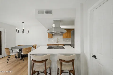 a dining room with furniture and a chandelier