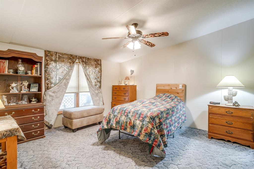436 Luke Road Springtown, TX 76082 - Photo 21 of 39 Bedroom featuring light carpet and ceiling fan