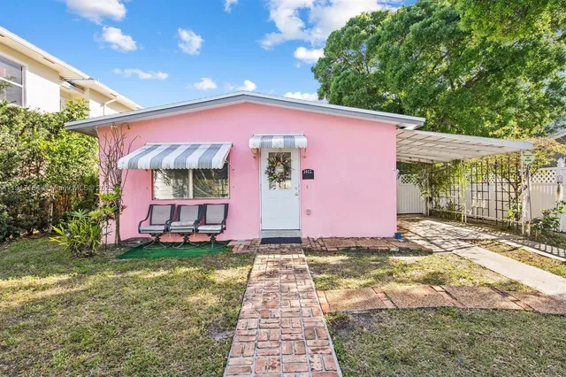 a front view of a house with a garden