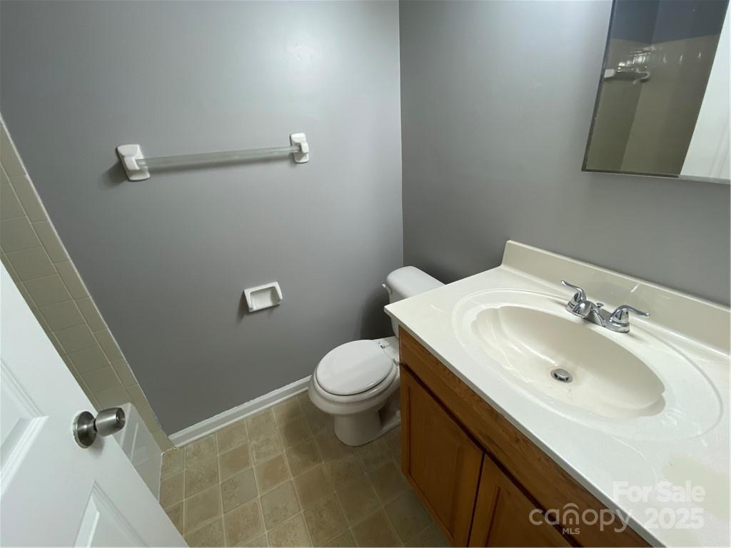 9409 Old Concord Road, Unit B Charlotte, NC 28213 - Photo 11 of 11 a bathroom with a sink toilet and mirror
