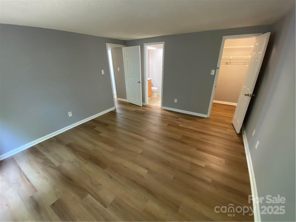 9409 Old Concord Road, Unit B Charlotte, NC 28213 - Photo 5 of 11 wooden floor in an empty room with a window