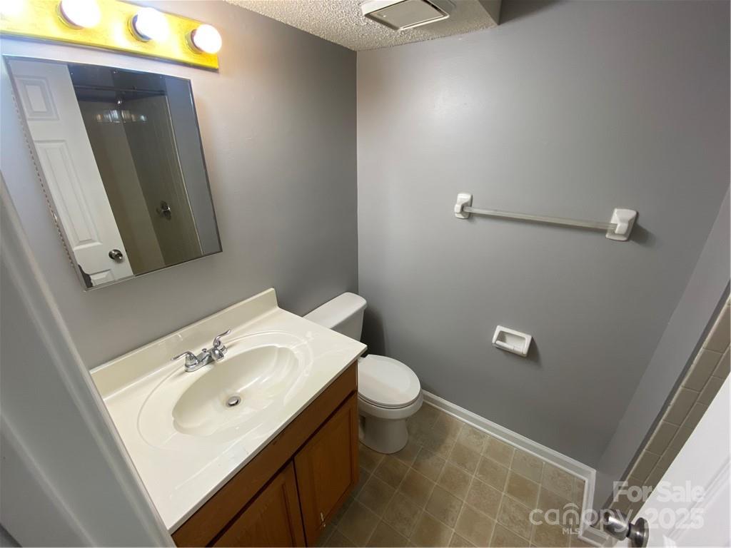 9409 Old Concord Road, Unit B Charlotte, NC 28213 - Photo 8 of 11 a bathroom with a sink toilet and mirror