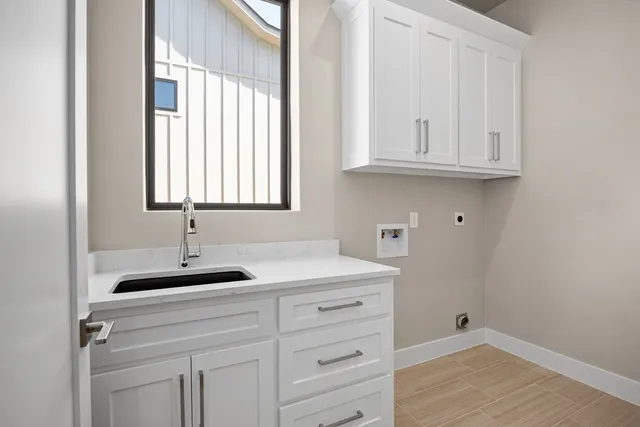 a kitchen with white cabinets and a sink