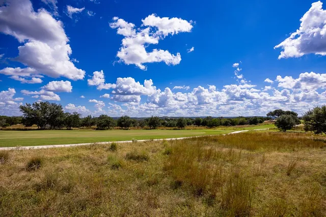 a view of a swimming pool with a yard