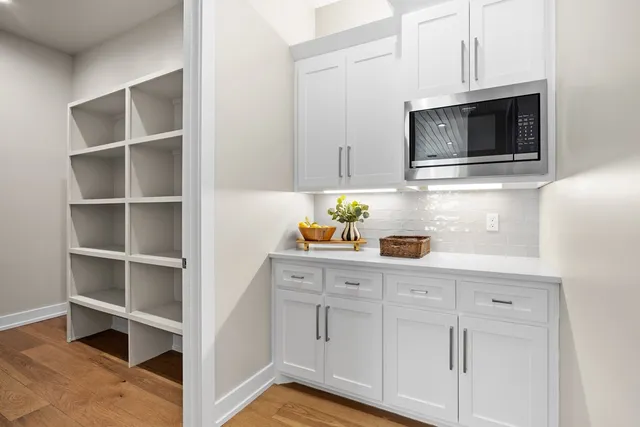 a kitchen with stainless steel appliances a stove microwave and cabinets