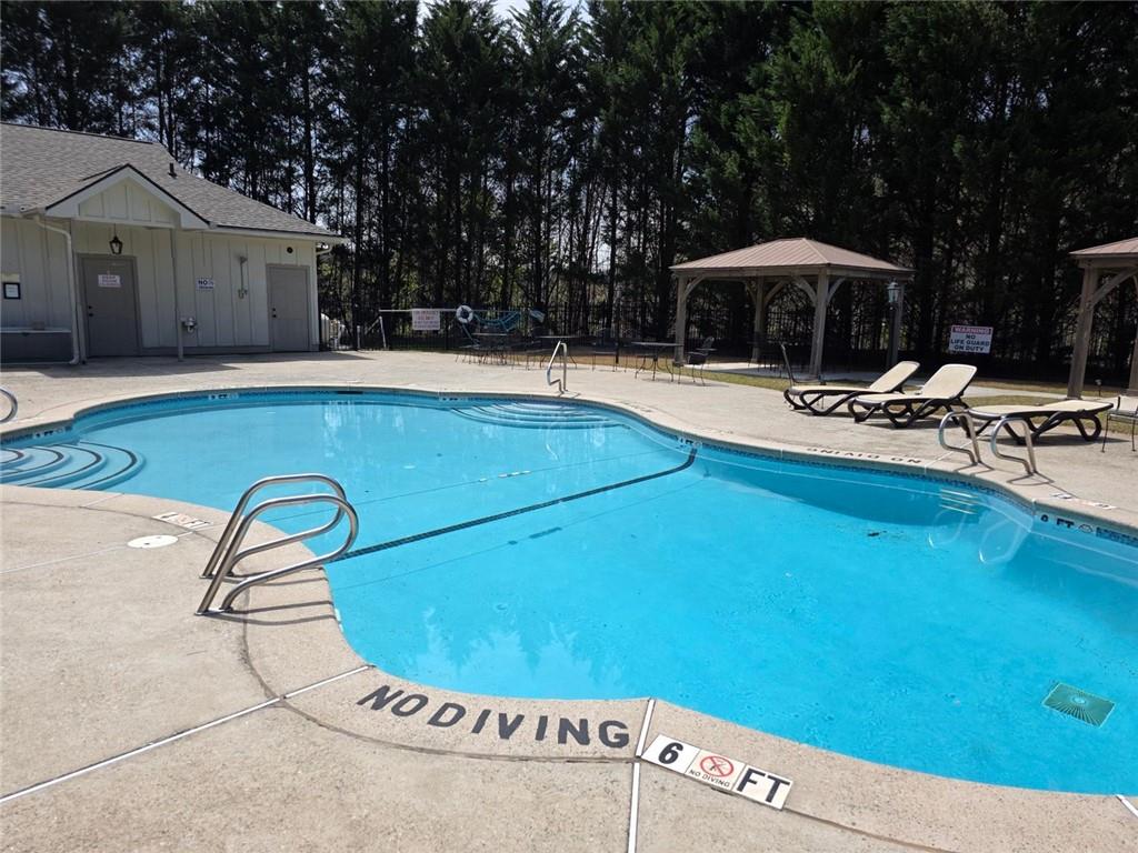 0 Rosen Strasse Helen, GA 30545 - Photo 3 of 6 a backyard of a house with table and chairs under an umbrella