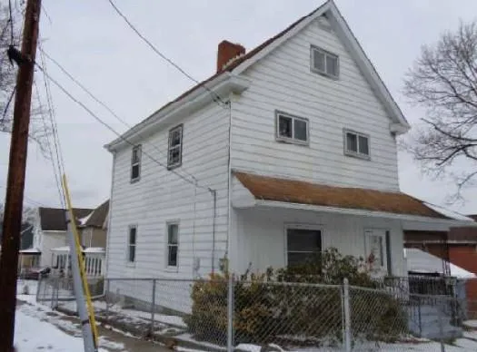 a front view of a house with plants