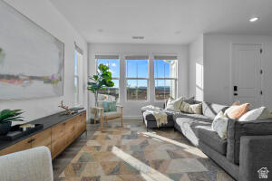 907 West Bright Ridge Ln Street, Unit 1430 St. George, UT 84790 - Photo 5 of 19 Bright living area featuring multiple windows, wood-finish flooring, recessed lighting, and a white paneled door