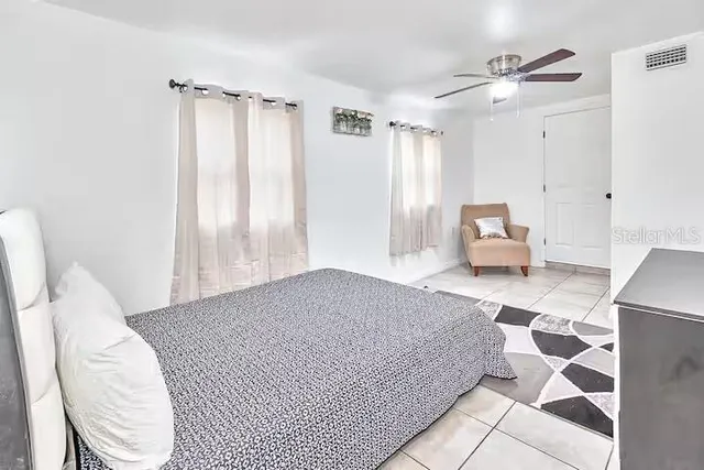 a bedroom with a bed and a painting on the wall