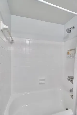 a bedroom with a large bed and a couch