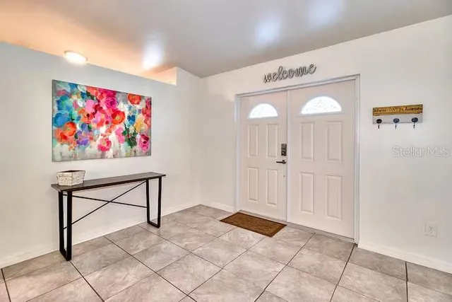 a dining room with furniture and a wooden floor