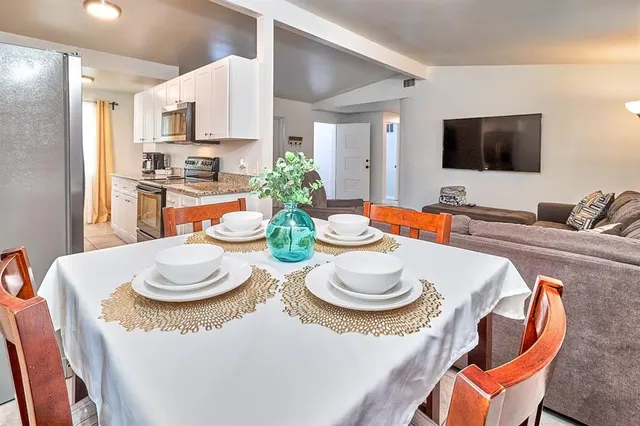 a view of a dining room with furniture and wooden floor