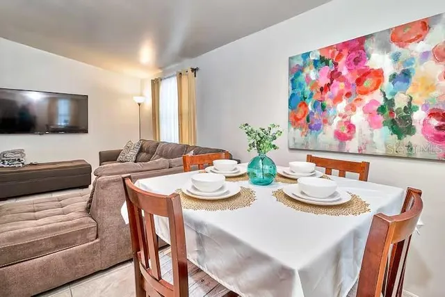 a view of a dining room with furniture and a potted plant