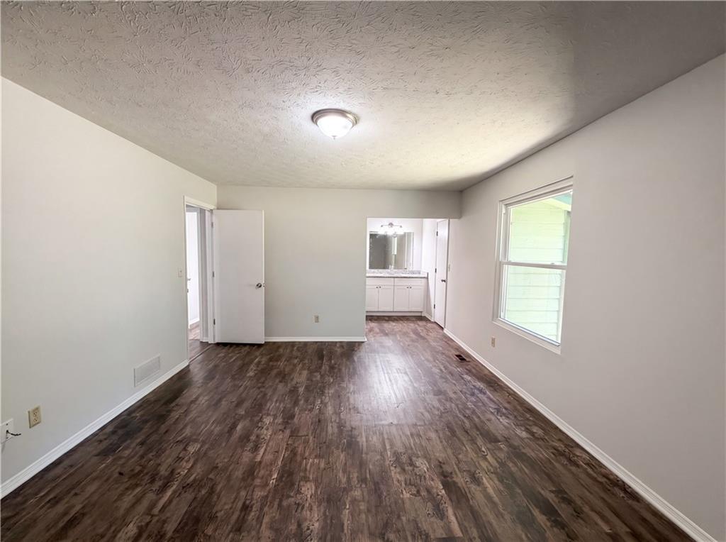 6830 Earlhurst Road Atlanta, GA 30349 - Photo 13 of 27 an empty room with wooden floor and windows