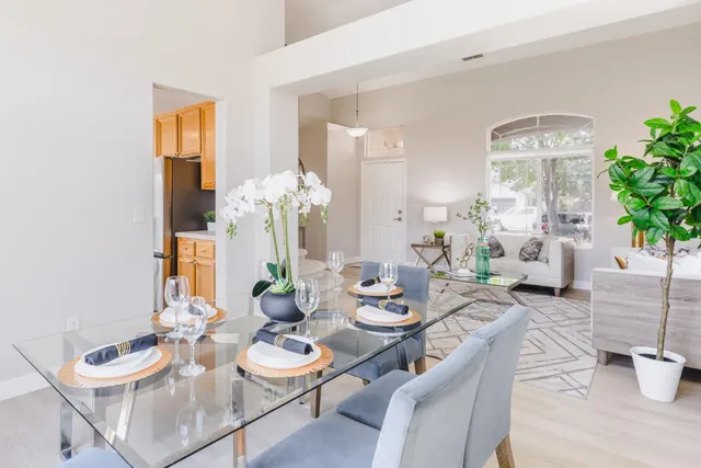 a kitchen with granite countertop a sink stove and refrigerator