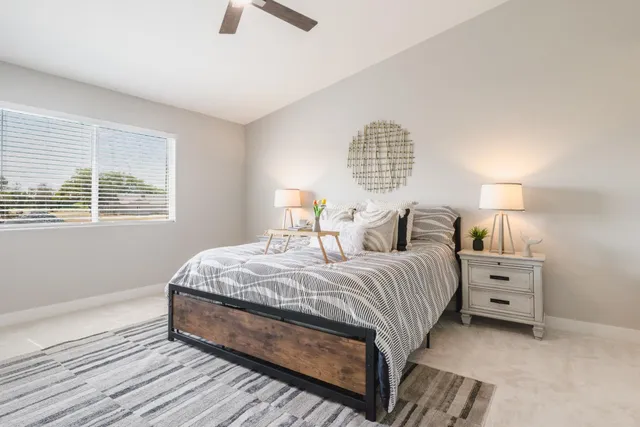 a bedroom with a bed and a chandelier