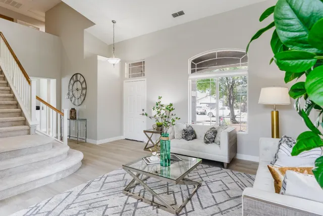 a living room with furniture and a chandelier