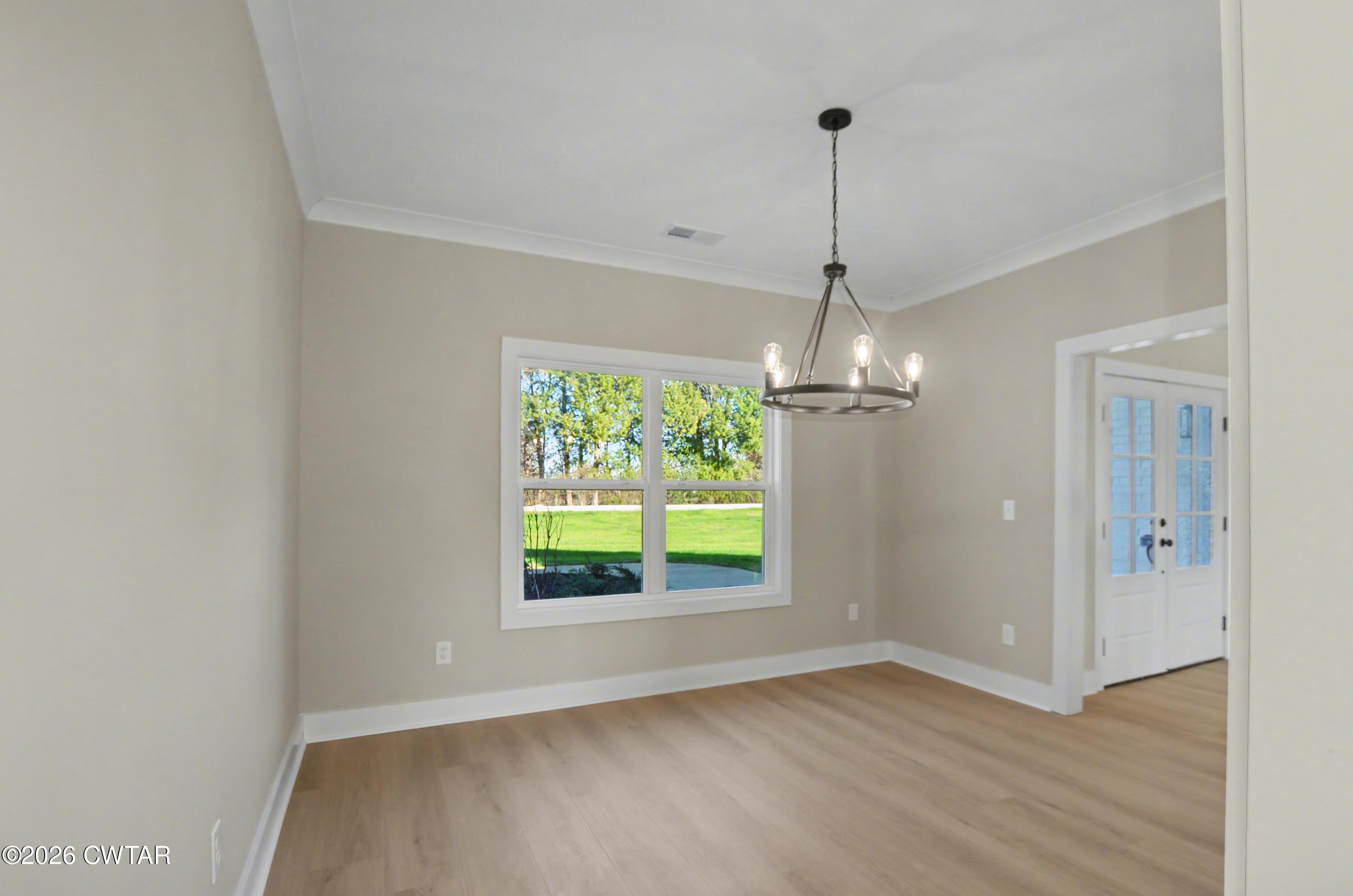 339 Marlow Cemetery Road Gadsden, TN 38337 - Photo 11 of 28 a view of a room with wooden floor outdoor view and windows