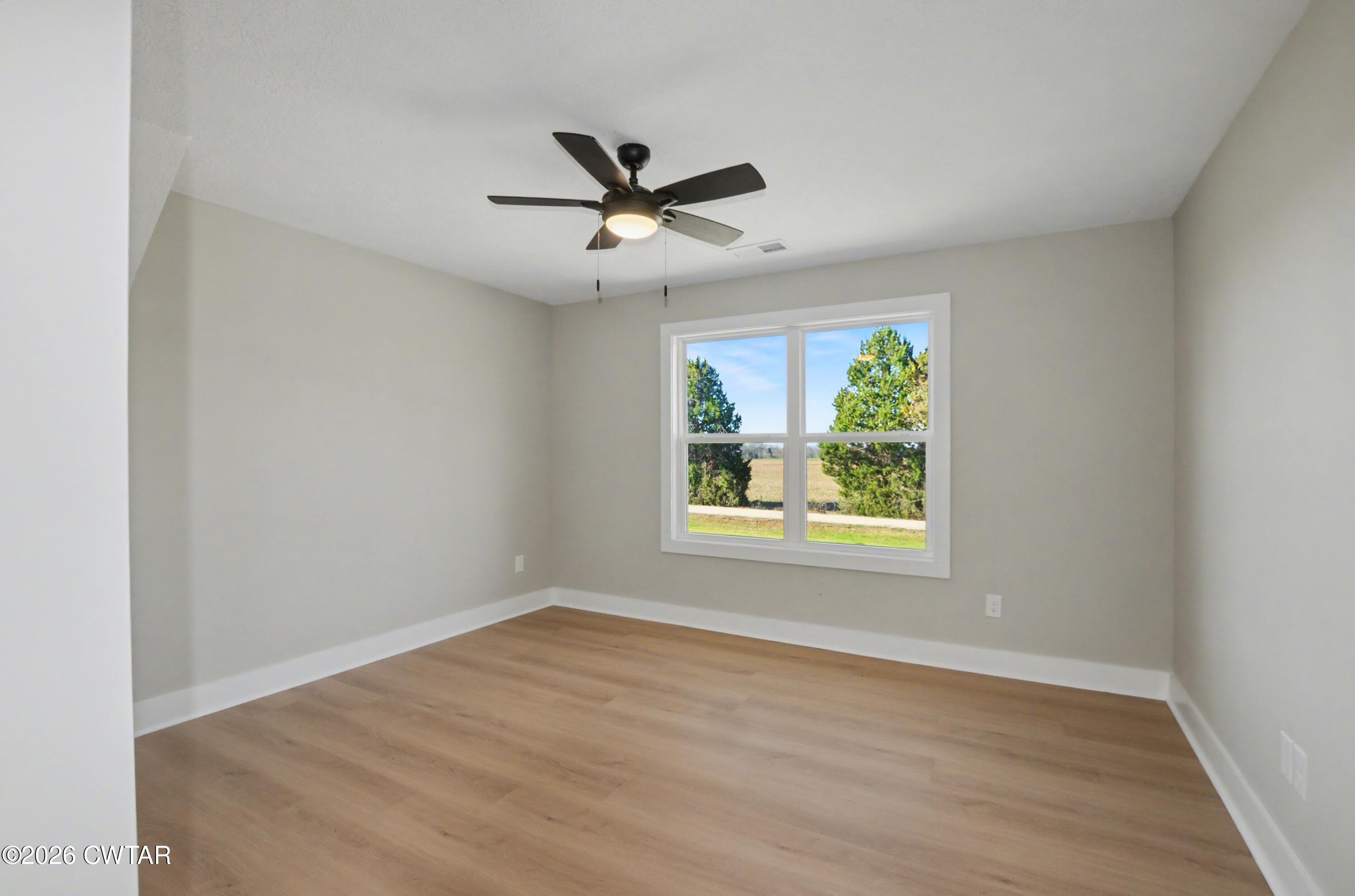 339 Marlow Cemetery Road Gadsden, TN 38337 - Photo 21 of 28 a view of an empty room with wooden floor and a window