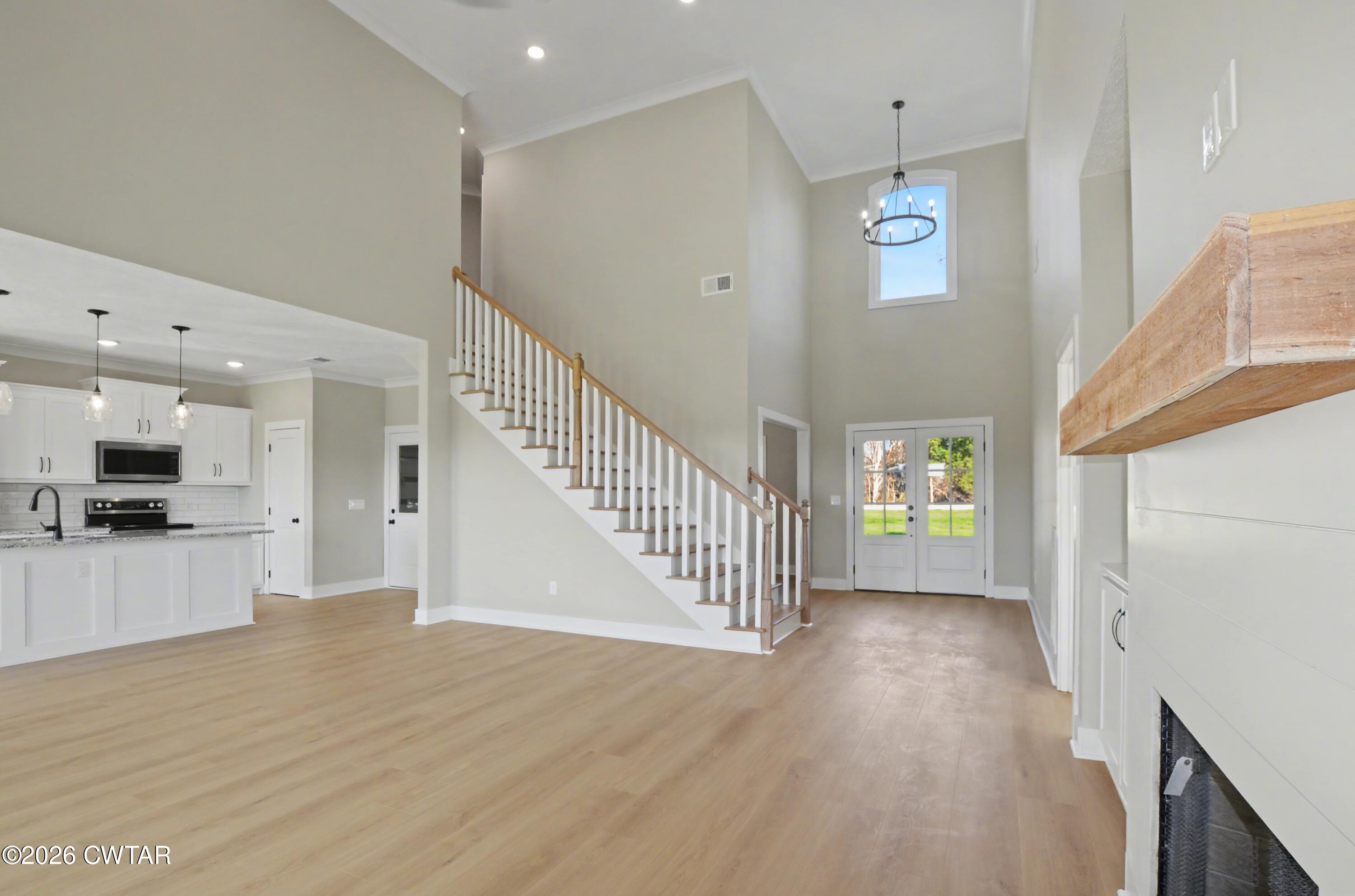 339 Marlow Cemetery Road Gadsden, TN 38337 - Photo 6 of 28 a view of a hallway with wooden floor and a kitchen
