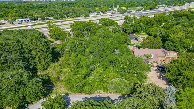 a view of a city with lush green forest