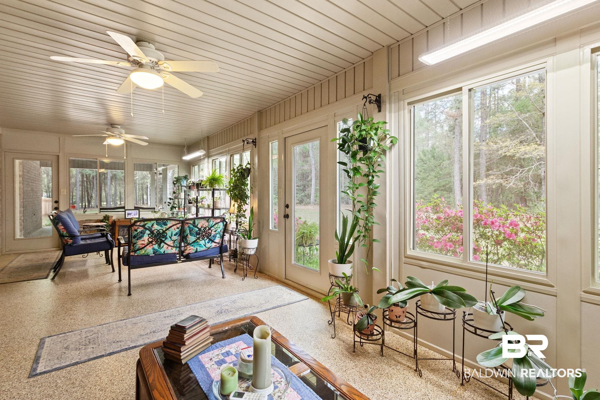 24250 Hack Road Bay Minette, AL 36507 - Photo 4 of 88 Sunroom / solarium featuring speckled floor, plenty of natural light, and wooden ceiling