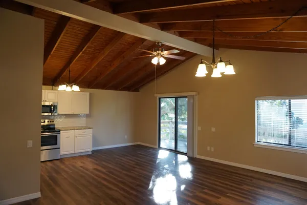 a view of a livingroom with hardwood floor and a ceiling fan