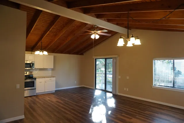 a view of a livingroom with hardwood floor and a ceiling fan