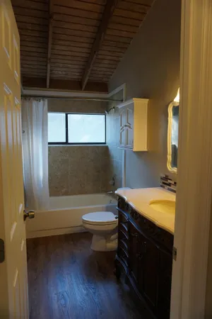 a bathroom with a sink a toilet and bathtub