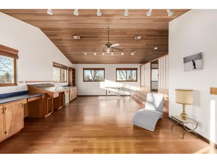 a living room with fireplace furniture and a wooden floor