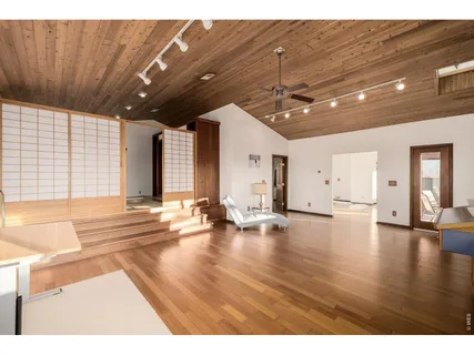 a view of a hall with wooden floor