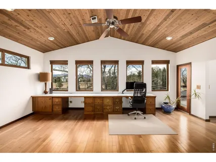 a backyard of a house with fire pit and outdoor seating