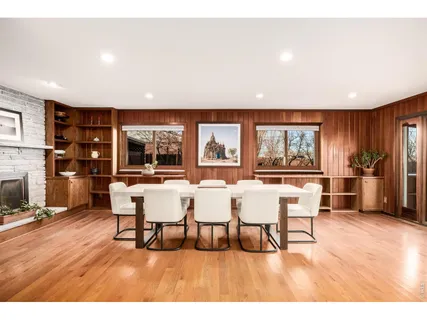 a dining room with furniture and wooden floor