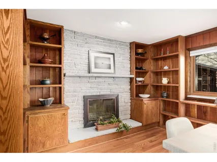 a living room with furniture a fireplace and a book shelf