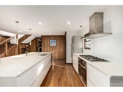 a large kitchen with a stove and a refrigerator