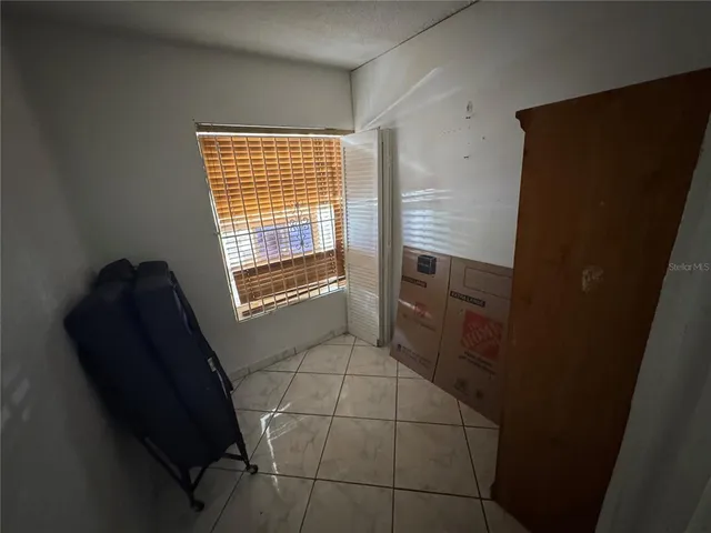 a kitchen with stainless steel appliances a refrigerator and a window